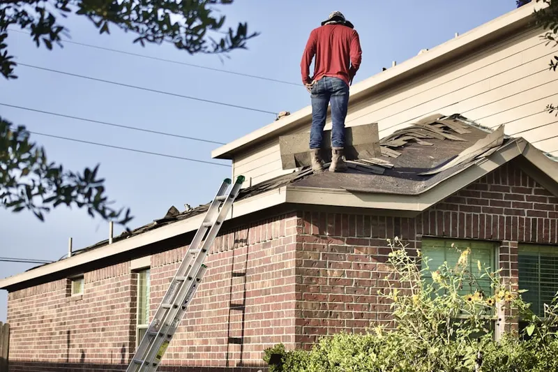 Professional roofer working on a residential roof in Round Lake